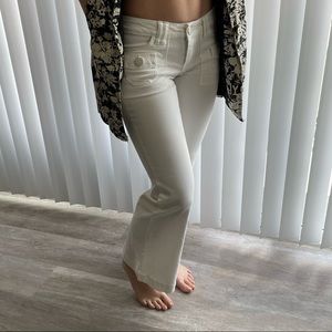 Square pocket cotton jeans with flare at hem.